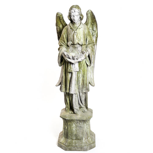 Standing angel with a serene facial expression holding a scalloped bowl on an ornate hexagonal pedestal.
