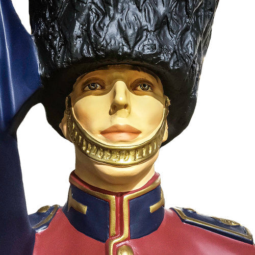 British royal guard statue in ornate old world European style uniform, tall bearskin hat, holding a flag, classical military theme Side View