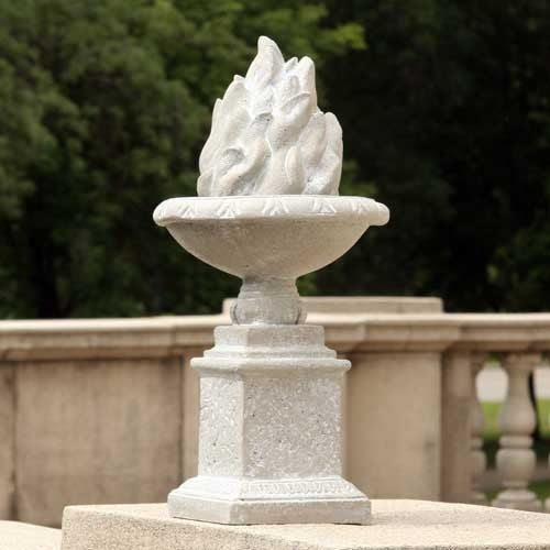 Ornate classical urn with sculpted flame motif on a square pedestal, featuring old world European and Renaissance design elements. Side View