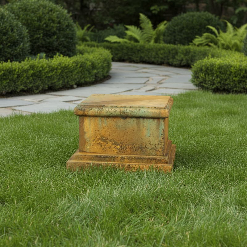 Ornate classical pedestal base with weathered old world European design and stepped architectural detailing. Side Angle