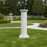 Classical Greek column with a rounded capital, smooth shaft, and ornate base in an old world European architectural style. Side Angle