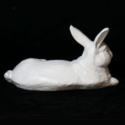 Reclining rabbit sculpture with classical old world European style and subtle ornate detailing in a lifelike pose. Different Angle