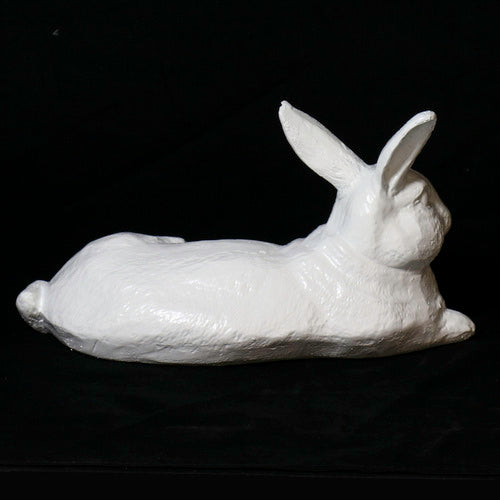 Reclining rabbit sculpture with classical old world European style and subtle ornate detailing in a lifelike pose. Different Angle