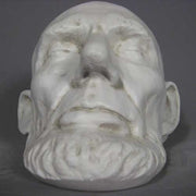 Classical old world European sculpted head with closed eyes, detailed facial features, and a prominent beard in Renaissance style. Different Angle