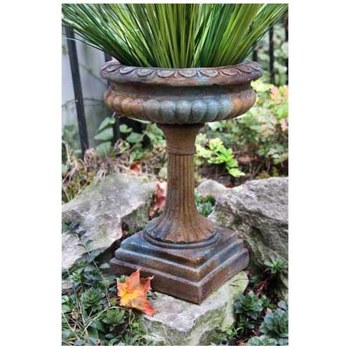 Ornate classical urn planter with fluted pedestal base and scalloped rim, featuring lush grass, old world European style Side Angle