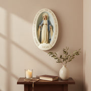 Virgin Mary statue in classical old world European style, set in an ornate oval frame with inscribed prayer and the year 1830. Side Angle