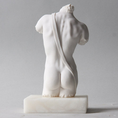 Classical Greek male torso sculpture with missing head and limbs, featuring detailed musculature and ornate carved base. Side Angle