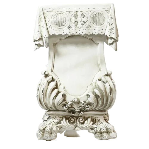Ornate Baroque-style pulpit with intricate carvings, classical motifs, and a decorative lace cloth draped over the top.