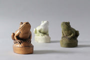 Frog figurine with ornate detailing, classical old world European style, perched on an oval base with subtle decorative accents. Different Angle
