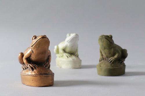 Frog figurine with ornate detailing, classical old world European style, perched on an oval base with subtle decorative accents. Different Angle