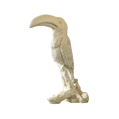 Toucan sculpture with ornate, old world European detailing and classical textured finish, perched on a stylized branch base.