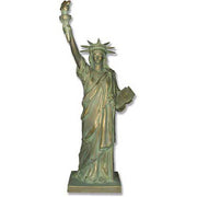 Statue of Liberty replica with classical draped robe, ornate crown, and raised torch in neoclassical architectural style.