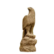 Eagle statue with detailed feathers perched on a rocky base, featuring classical old world European sculptural style.