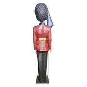 British royal guard statue in ornate old world European style uniform, tall bearskin hat, holding a flag, classical military theme Other Angle