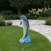Dolphin figurine leaping above ornate swirling waves, sculpted in a classical old world European style. Side Angle