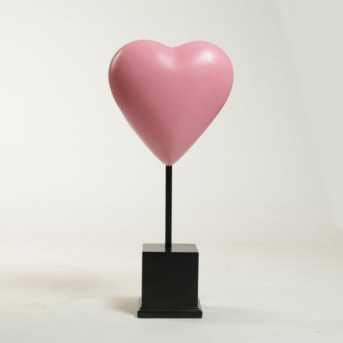 Heart-shaped sculpture on a square pedestal stand, featuring smooth, minimalist lines with a classical European influence. Side View