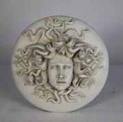 Medusa head relief with intricate serpentine hair, classical Greek style, ornate detailing, and dramatic facial expression. Side View