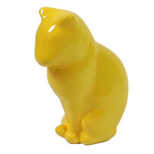 Cat figurine with smooth, minimalist lines and a stylized, classical form inspired by old world European sculpture.