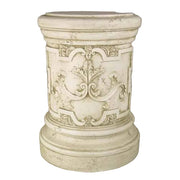 Ornate classical pedestal with old world European scrollwork and Baroque floral motifs, featuring rounded base and top.