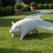 Pig statue with classical old world European style, featuring rounded form, subtle facial details, and a gentle, ornate expression. Side Angle