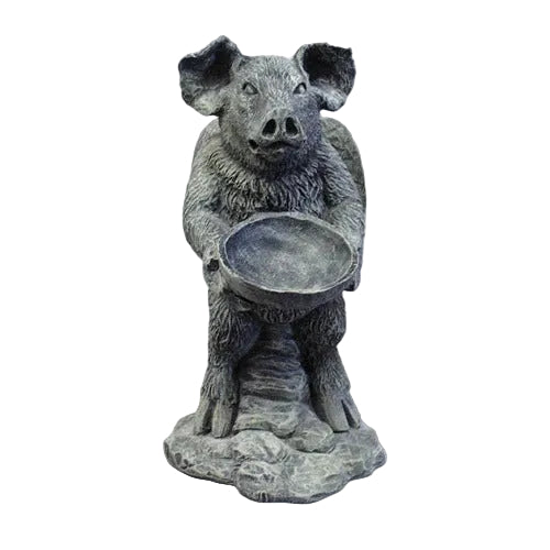 Standing upright pig statue holding a round bowl on a rock-like base.