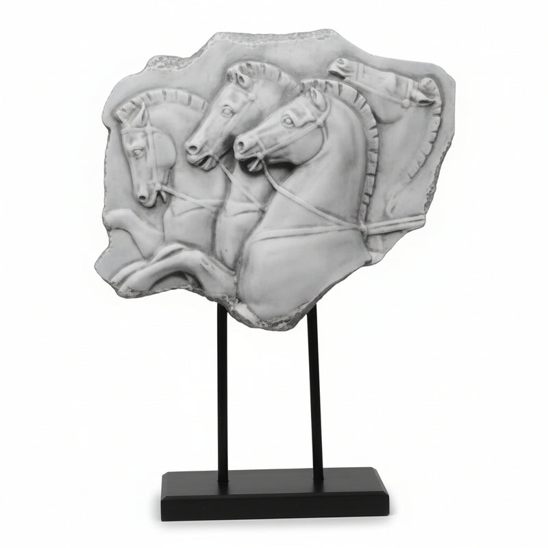 Classical Greek relief sculpture featuring three ornate horses in dynamic motion, mounted on a minimalist black stand.