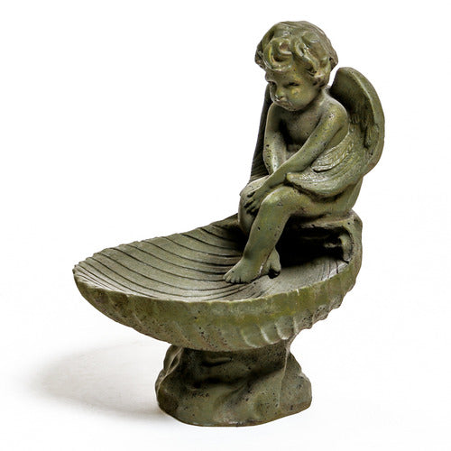 Winged cherub sitting on the edge of a shell-shaped bowl on a round pedestal base.