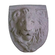 Lion head relief on a shield-shaped plaque, featuring ornate, old world European classical detailing and expressive facial features.