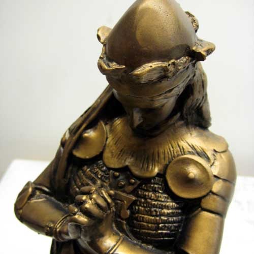 Kneeling medieval knight in ornate armor, hands clasped in prayer, classical old world European style with Gothic detailing. Side Angle
