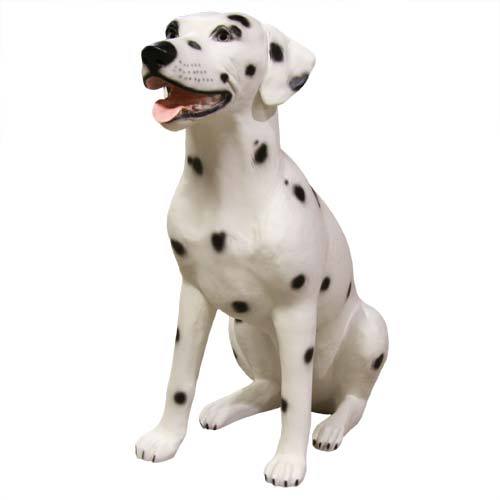 Dalmatian dog statue in a seated pose with classic black spots, sculpted in a naturalistic, old world European style.