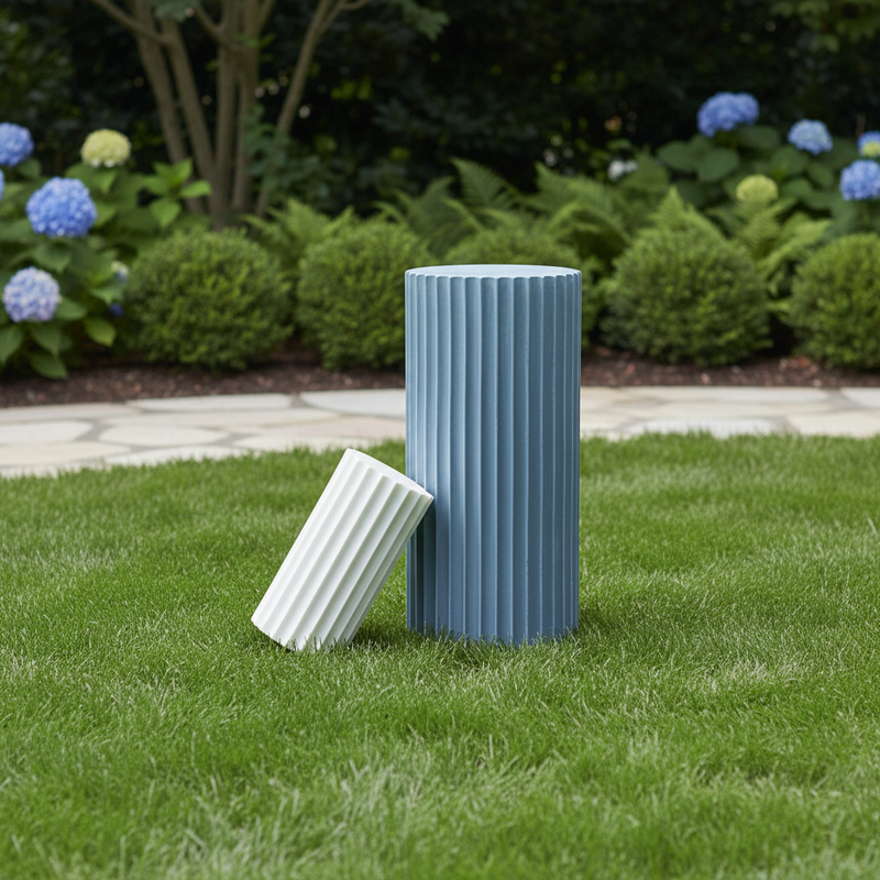Fluted column-inspired candle set with classical Greek architectural style and vertical grooves, one upright and one tilted. Side Angle