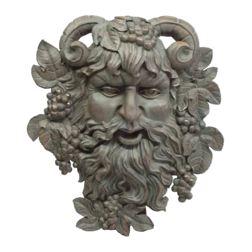 Grotesque bearded face with ram horns, grape clusters, and ornate leaves in an old world European classical style.