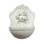 Wall fountain with ornate classical face relief, old world European style, featuring intricate Baroque and Renaissance detailing.
