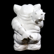 Grotesque gargoyle statue with exaggerated features, large ears, and a mischievous expression in old world European style. Side Angle