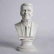 Classical-style bust of a distinguished man in a suit and tie with detailed facial features and an ornate pedestal base. Side View