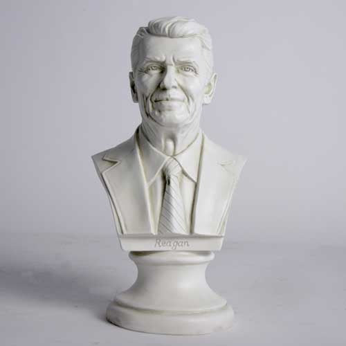 Classical-style bust of a distinguished man in a suit and tie with detailed facial features and an ornate pedestal base. Side View