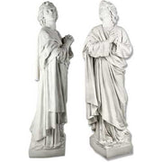 Two classical Renaissance-style statues of robed figures standing in prayer with upward gazes and detailed drapery.
