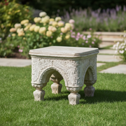 Ornate old world European stool with classical arches, intricate Baroque carvings, and four sculpted legs in a medieval style. Side Angle