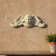 Cherub face with curled hair and ornate wings in classical Baroque style, featuring intricate old world European detailing. Side View