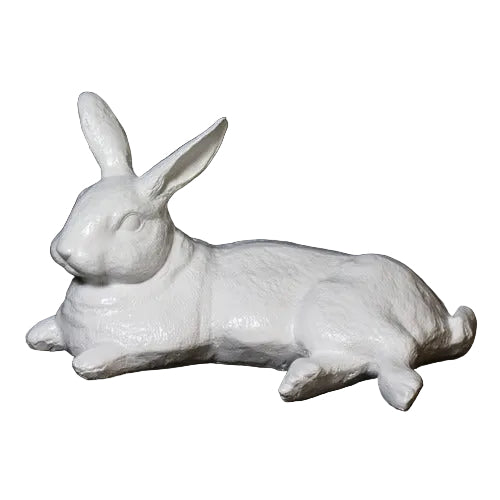 Reclining rabbit sculpture with classical old world European style and subtle ornate detailing in a lifelike pose.