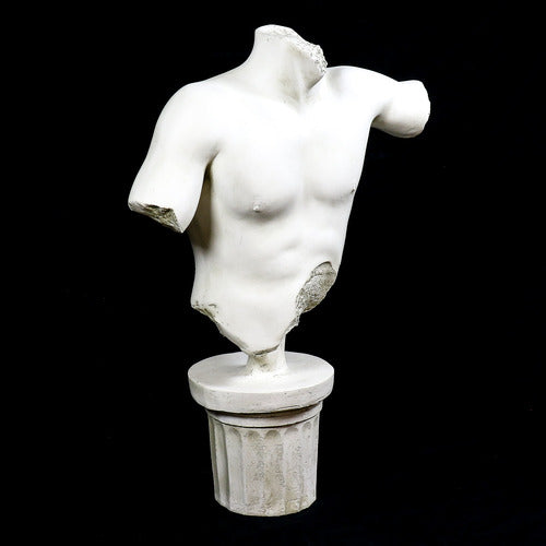 Classical Greek male torso sculpture with missing head and arms, displayed on an ornate fluted pedestal in old world European style. Different Angle