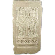 Gothic-style relief panel featuring two robed figures beneath ornate arches with intricate medieval detailing and classical motifs.