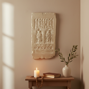 Gothic-style relief panel featuring two robed figures beneath ornate arches with intricate medieval detailing and classical motifs. Side View
