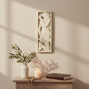 Classical relief panel featuring a nude figure playing panpipes amid ornate floral motifs in an old world European style. Side View