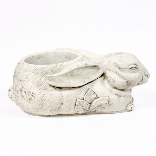 Rabbit-shaped planter with ornate floral motif, featuring old world European style and filled with yellow and orange flowers. Different Angle