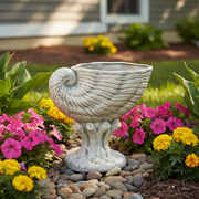 Nautilus shell-shaped vessel with ornate, old world European detailing and classical pedestal base. Side Angle