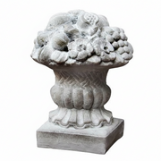 Ornate classical urn with intricate fruit and floral relief, featuring old world European and Baroque decorative detailing.