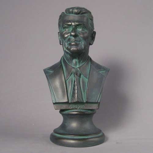 Classical-style bust of a distinguished man in a suit and tie with detailed facial features and an ornate pedestal base. Additional Angle