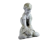 Boy crouching atop a turtle in an old world European style, featuring classical, ornate sculptural details and gentle expression.