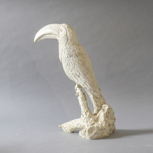 Toucan sculpture with ornate, old world European detailing and classical textured finish, perched on a stylized branch base. Different Angle